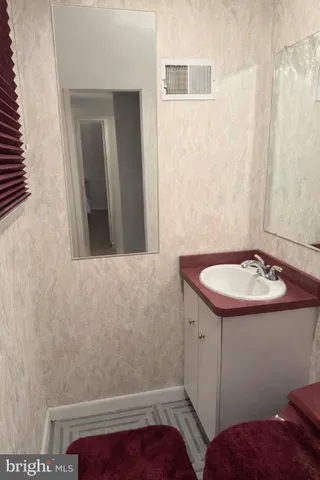 a bathroom with a sink and mirror