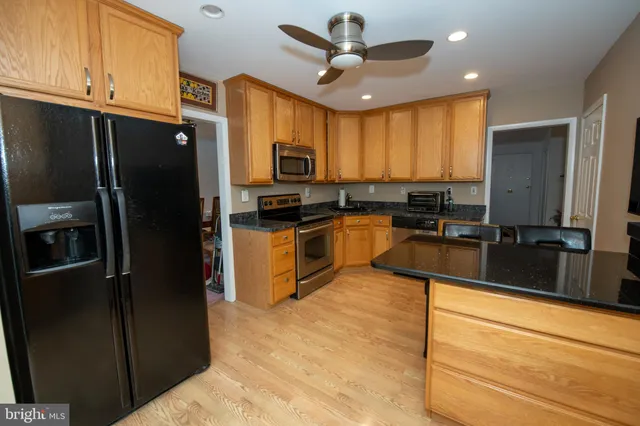 a kitchen with stainless steel appliances a refrigerator sink and microwave
