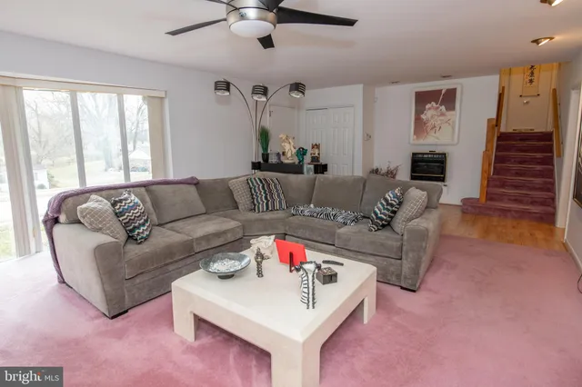 a living room with furniture fireplace and a window