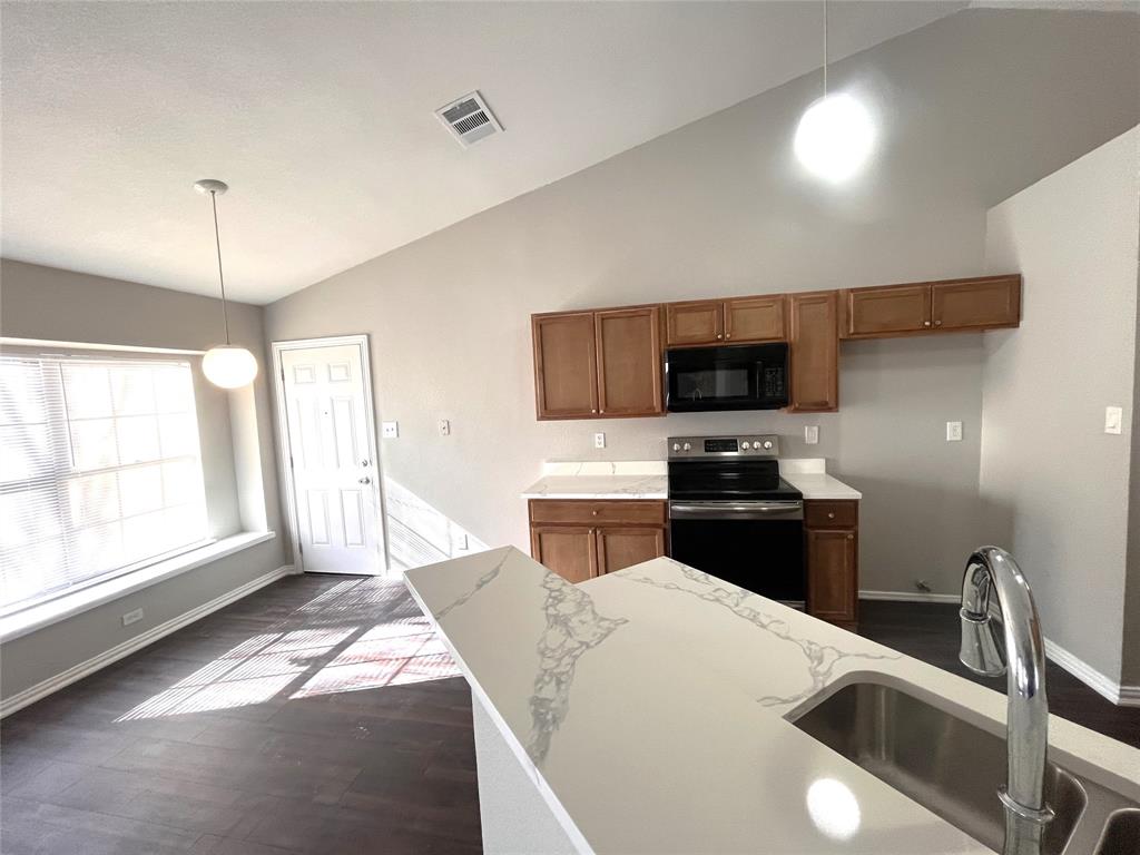 432 East Belt Line Road Cedar Hill, TX 75104 - Photo 13 of 30 a kitchen with a sink a counter top space stainless steel appliances and a window