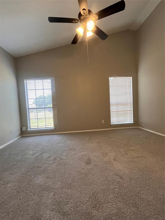 432 East Belt Line Road Cedar Hill, TX 75104 - Photo 17 of 30 en empty room with windows and chandelier fan