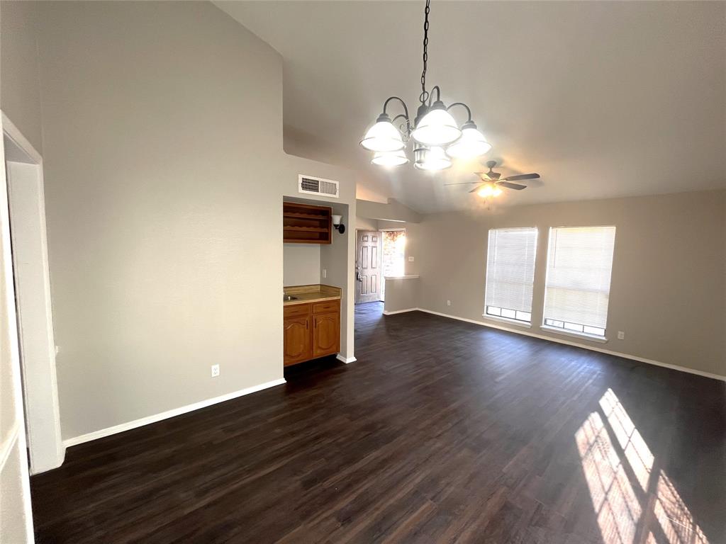 432 East Belt Line Road Cedar Hill, TX 75104 - Photo 2 of 30 a view of a room with wooden floor a kitchen space and a window