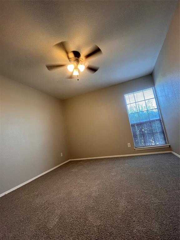 432 East Belt Line Road Cedar Hill, TX 75104 - Photo 22 of 30 an empty room with a chandelier fan and windows