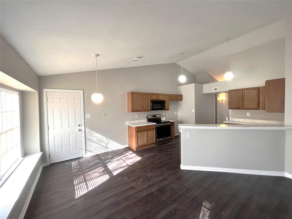 432 East Belt Line Road Cedar Hill, TX 75104 - Photo 4 of 30 a view of kitchen with microwave a refrigerator and a stove top oven