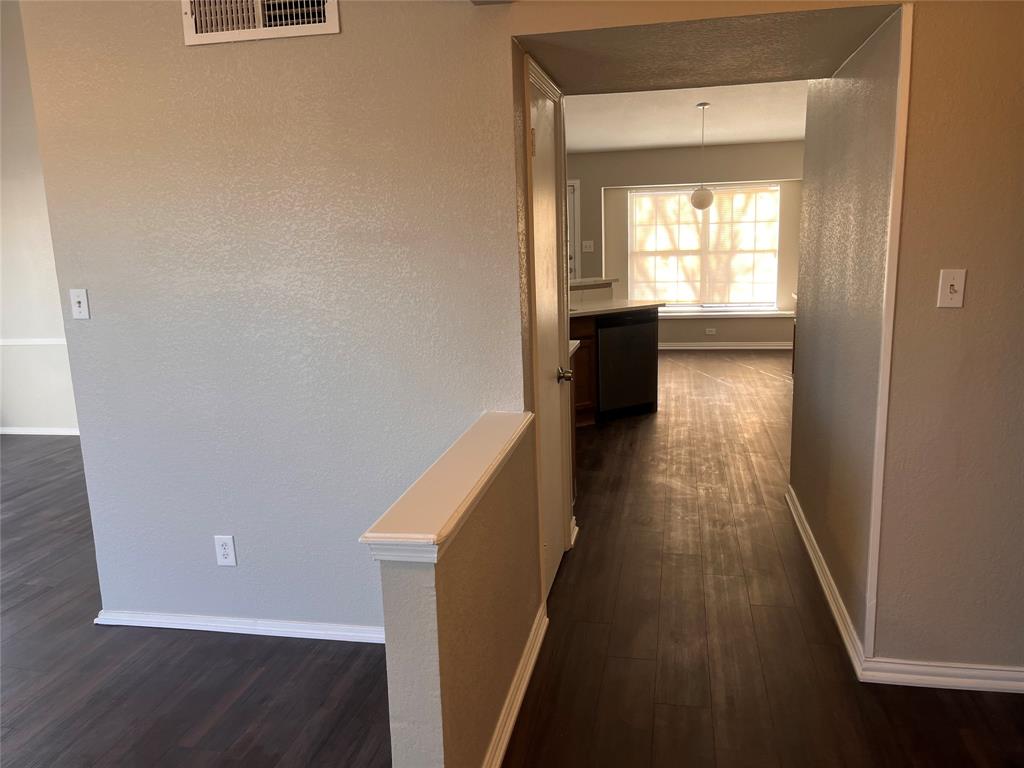 432 East Belt Line Road Cedar Hill, TX 75104 - Photo 6 of 30 a view of a hallway with wooden floor and staircase