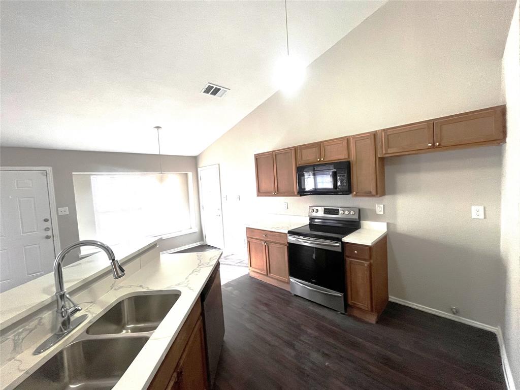 432 East Belt Line Road Cedar Hill, TX 75104 - Photo 10 of 30 a kitchen with stainless steel appliances granite countertop a sink stove and refrigerator