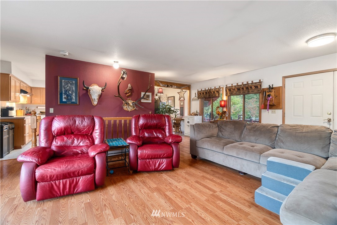 199 Jeffries Road Chehalis, WA 98532 - Photo 11 of 40 a living room with furniture a couch and paintings on the wall