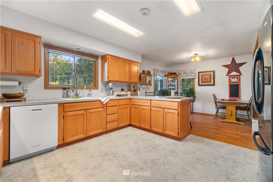 199 Jeffries Road Chehalis, WA 98532 - Photo 13 of 40 a kitchen with stainless steel appliances granite countertop sink window and white cabinets