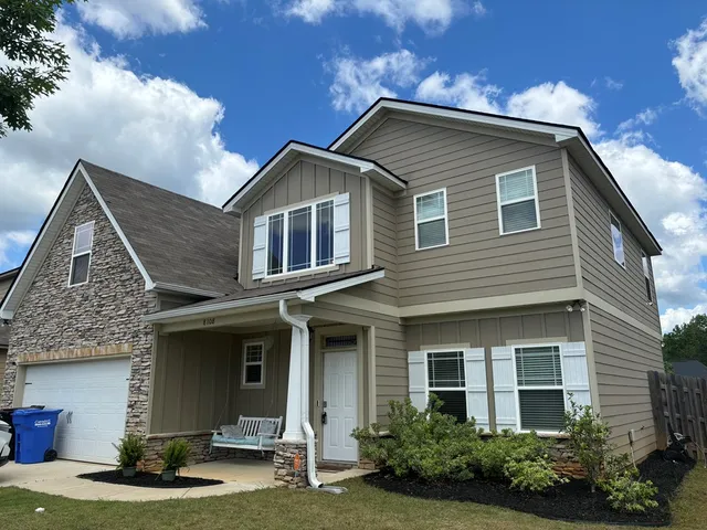 a front view of a house with garden