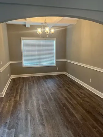 a view of room with window and hardwood floor