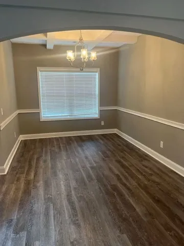 a view of room with window and hardwood floor