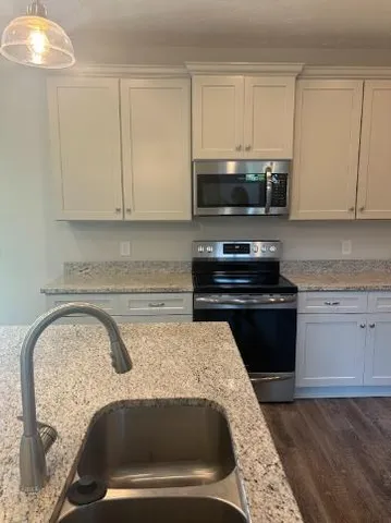 a kitchen with a sink and cabinets
