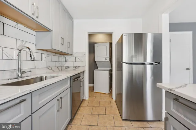 a kitchen with a refrigerator sink and cabinets