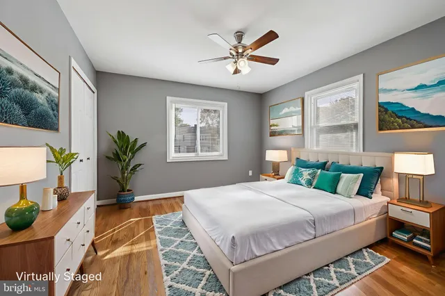 a bedroom with a large bed and a potted plant