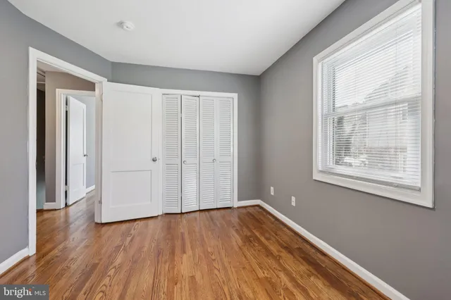 a view of a room with wooden floor and windows