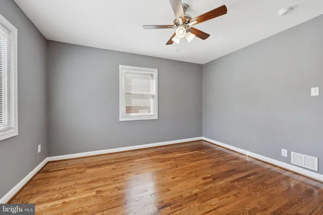 a view of a room with wooden floor and windows