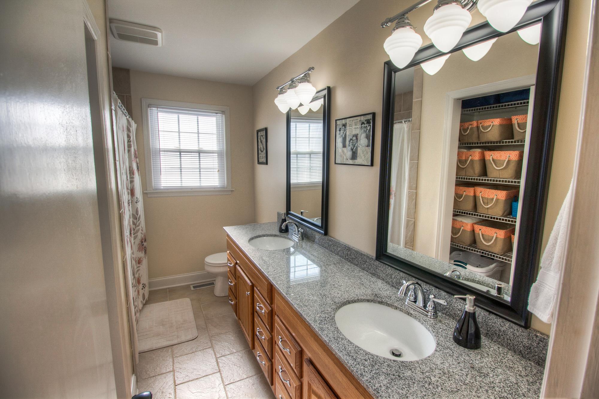4509 Baton Rouge Drive Hermitage, TN 37076 - Photo 14 of 30 a bathroom with a granite countertop double vanity sink and a mirror