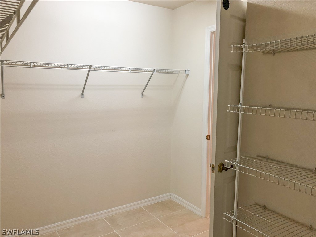 1823 Ridgemoor Street Lehigh Acres, FL 33972 - Photo 11 of 20 a bathroom with a glass shower door