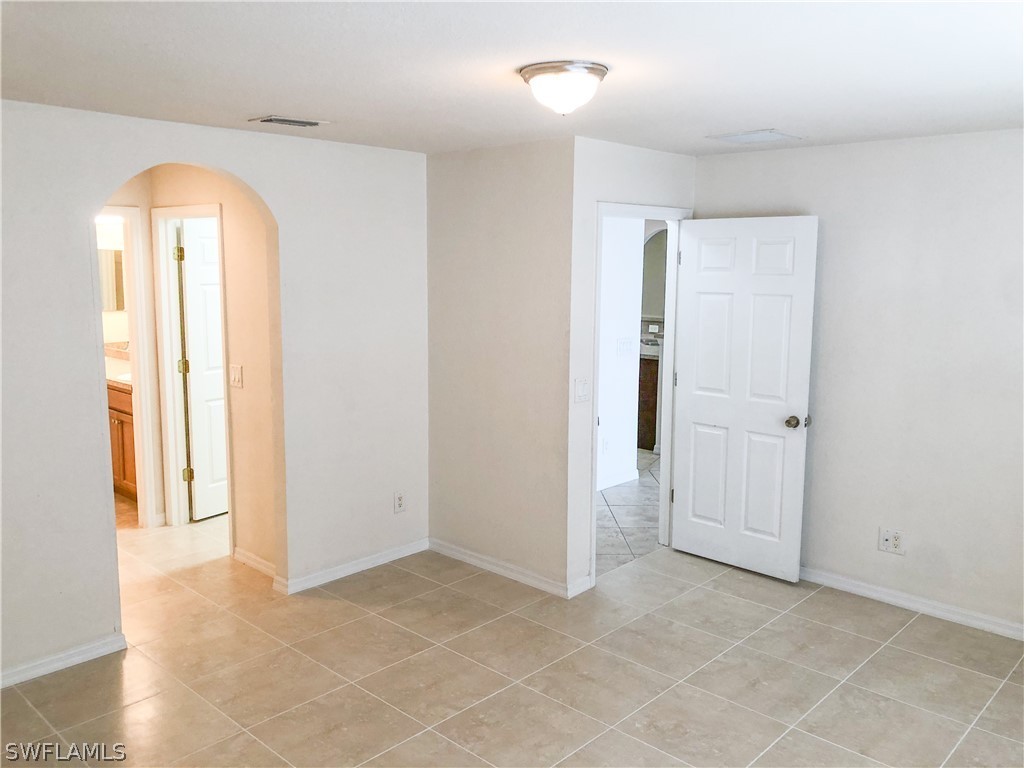 1823 Ridgemoor Street Lehigh Acres, FL 33972 - Photo 20 of 20 an empty room with closet and a bathroom