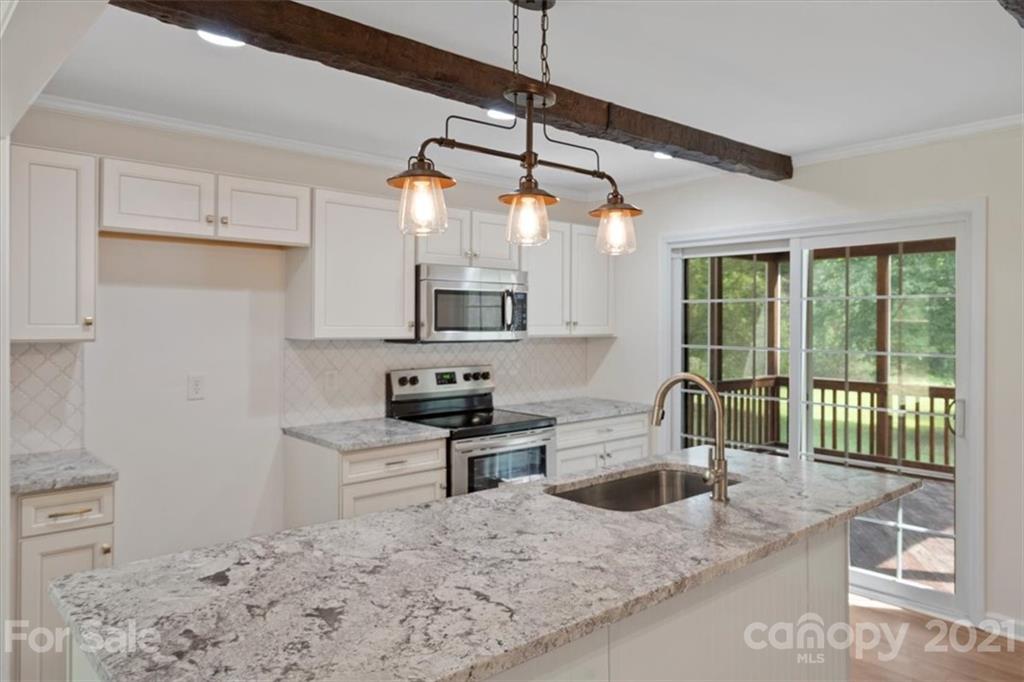 2665 Holbrook Road Fort Mill, SC 29715 - Photo 14 of 44 a kitchen with stainless steel appliances granite countertop a stove a sink and a refrigerator