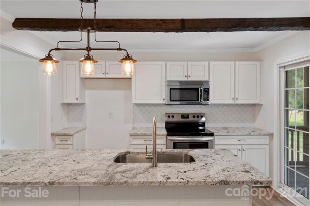 2665 Holbrook Road Fort Mill, SC 29715 - Photo 15 of 44 a kitchen with granite countertop a stove and a white cabinets