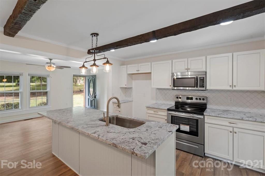 2665 Holbrook Road Fort Mill, SC 29715 - Photo 16 of 44 a kitchen with stainless steel appliances granite countertop a sink a stove and cabinets