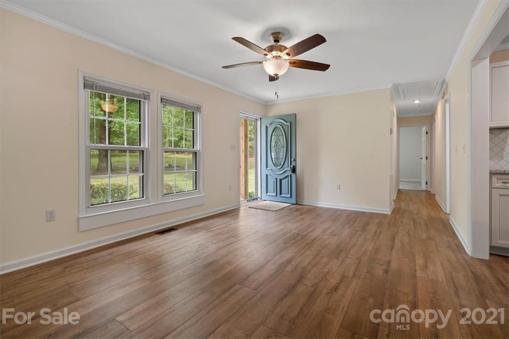 2665 Holbrook Road Fort Mill, SC 29715 - Photo 7 of 44 a view of an empty room with wooden floor and a window