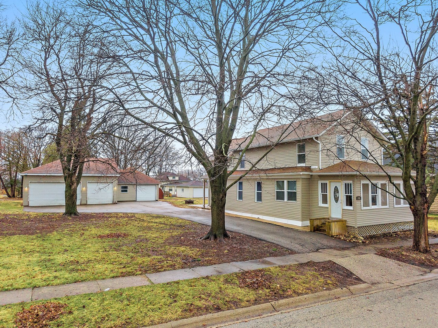 162 Park Street Hampshire, IL 60140 - Photo 1 of 25 a front view of a house with a yard covered with snow and trees