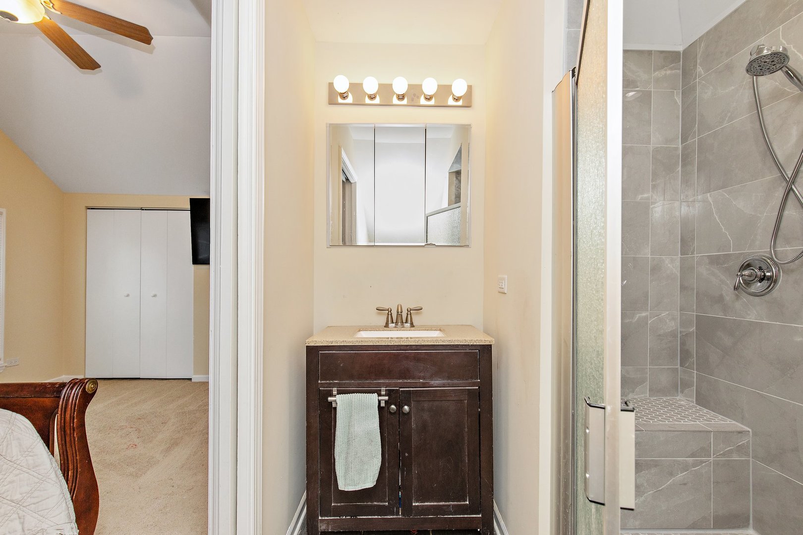 162 Park Street Hampshire, IL 60140 - Photo 13 of 25 a bathroom with a sink a mirror and a shower