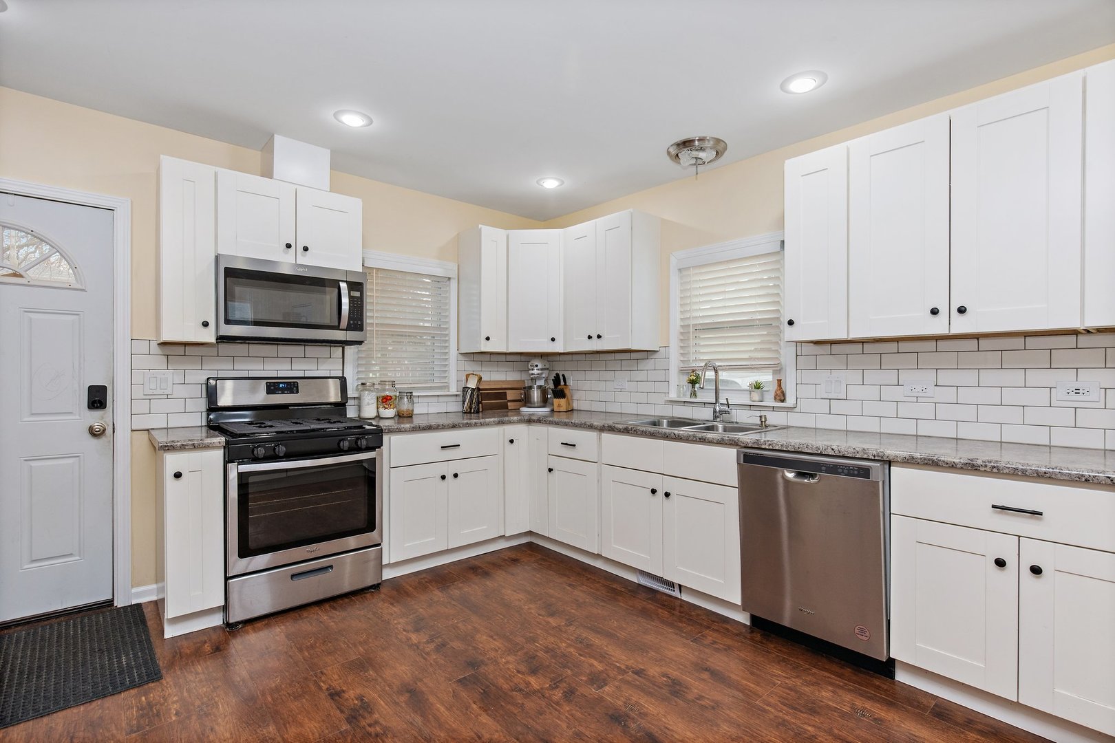 162 Park Street Hampshire, IL 60140 - Photo 9 of 25 a kitchen with granite countertop white cabinets and stainless steel appliances