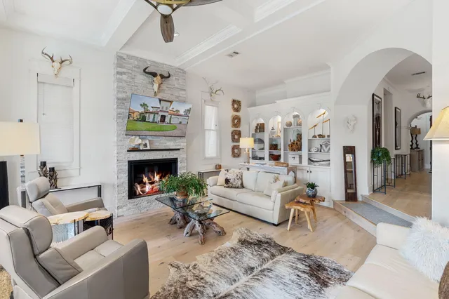 a living room with furniture and painting on the wall