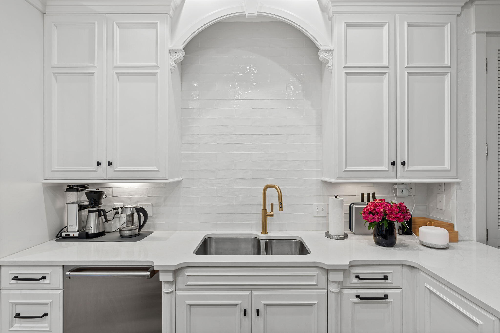 1821 Baytowne Avenue Miramar Beach, FL 32550 - Photo 16 of 63 a kitchen with white cabinets and a sink