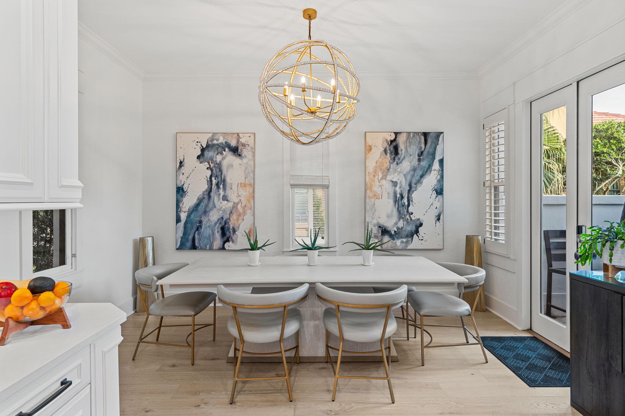 1821 Baytowne Avenue Miramar Beach, FL 32550 - Photo 17 of 63 a dining room with wooden floor a chandelier a wooden table and chairs