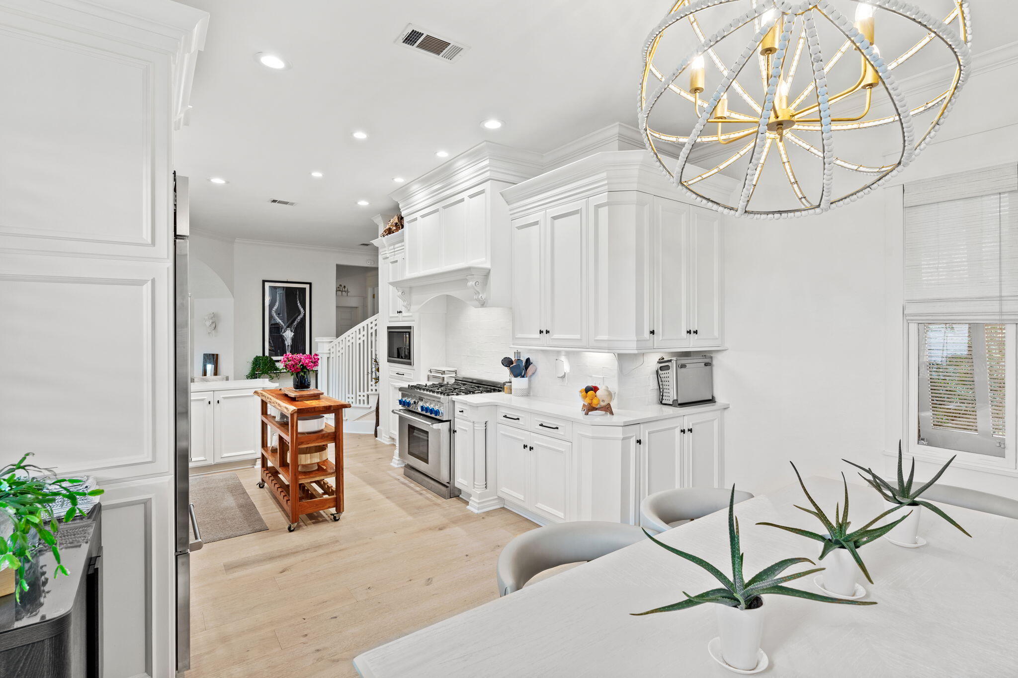 1821 Baytowne Avenue Miramar Beach, FL 32550 - Photo 18 of 63 a kitchen with white cabinets and chairs