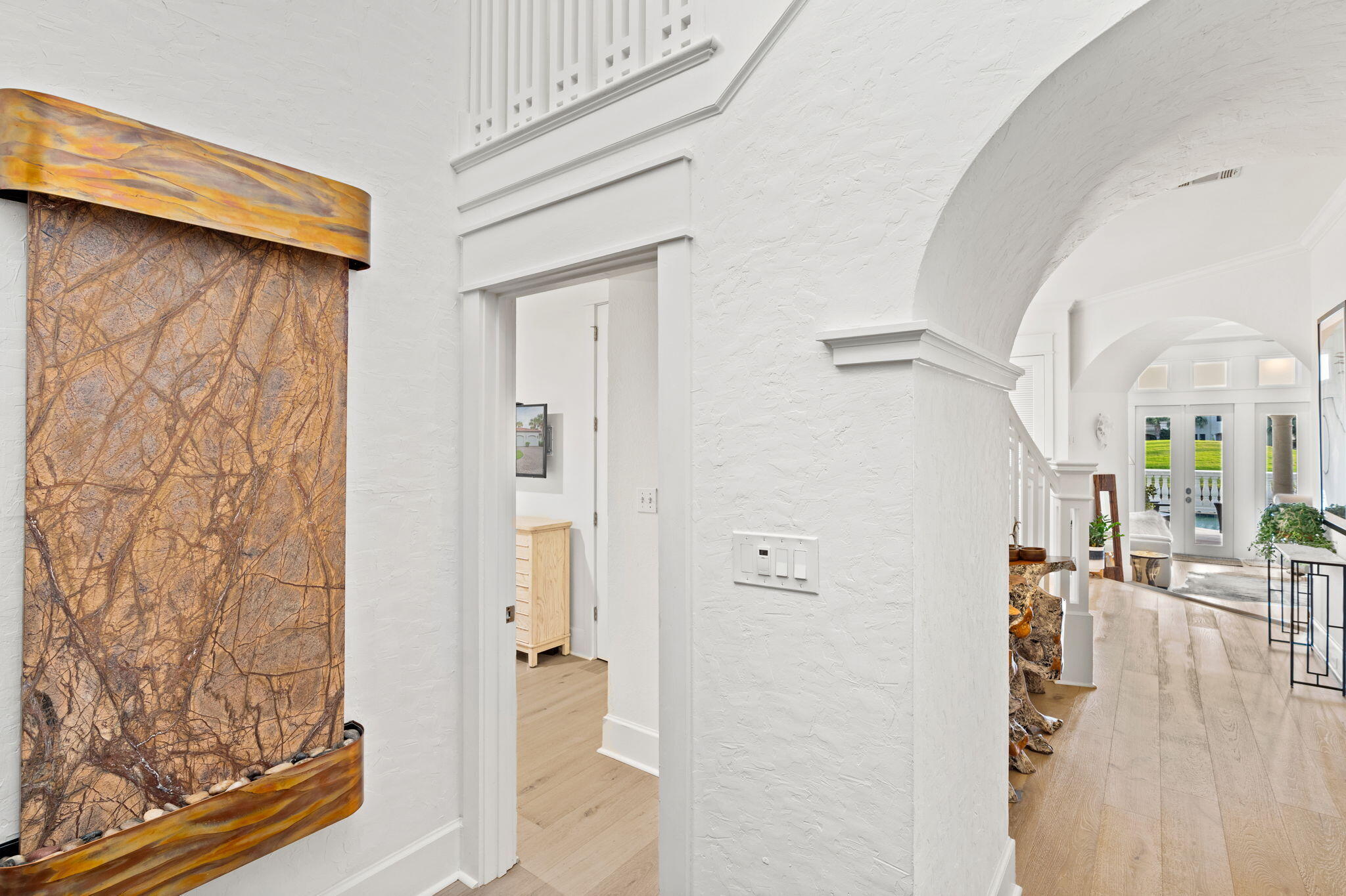 1821 Baytowne Avenue Miramar Beach, FL 32550 - Photo 7 of 63 a view of a hallway with wooden floor and a living room