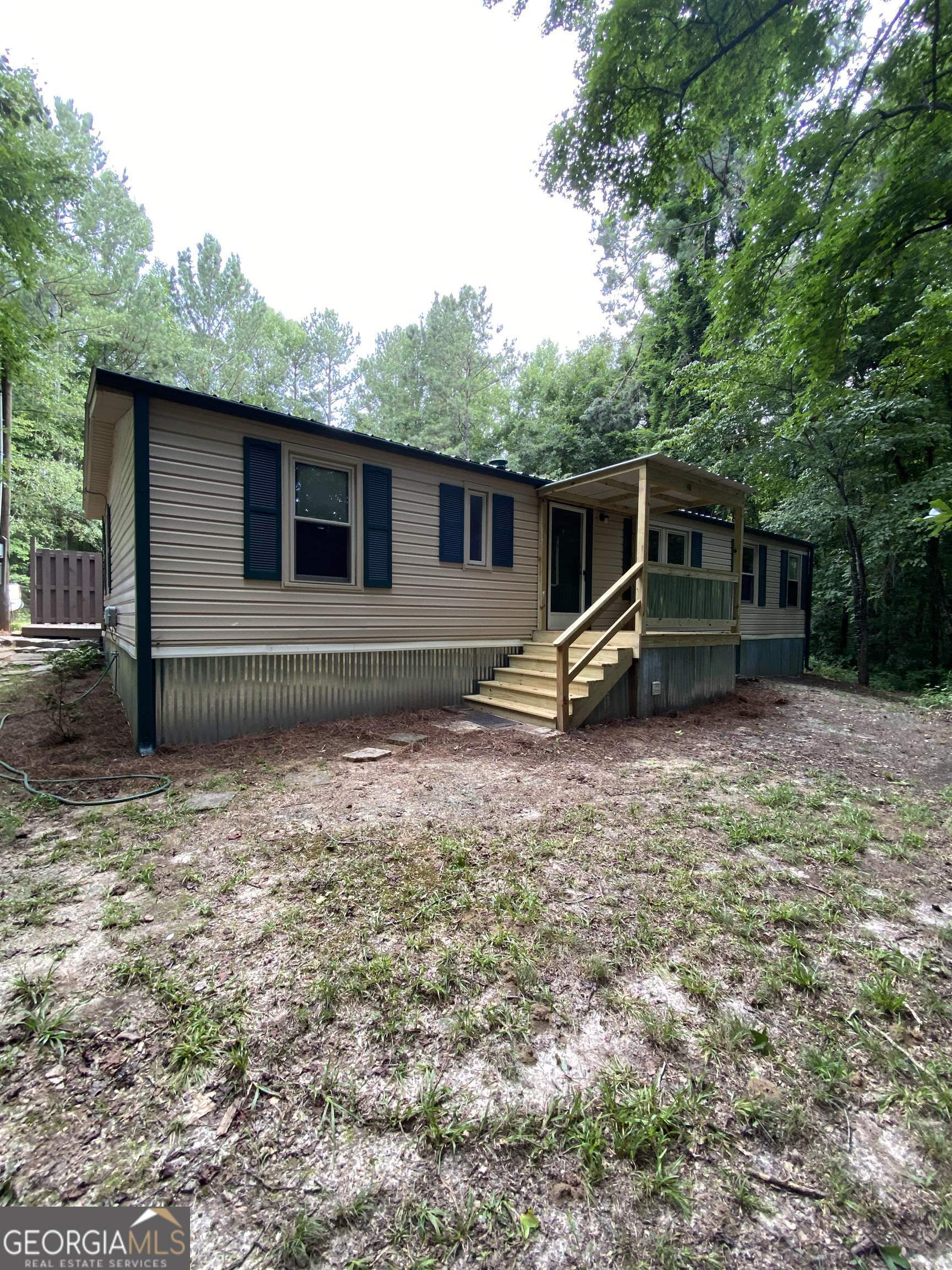 218 Roy Morgan Road Carrollton, GA 30116 - Photo 1 of 1 a backyard of a house with barbeque oven