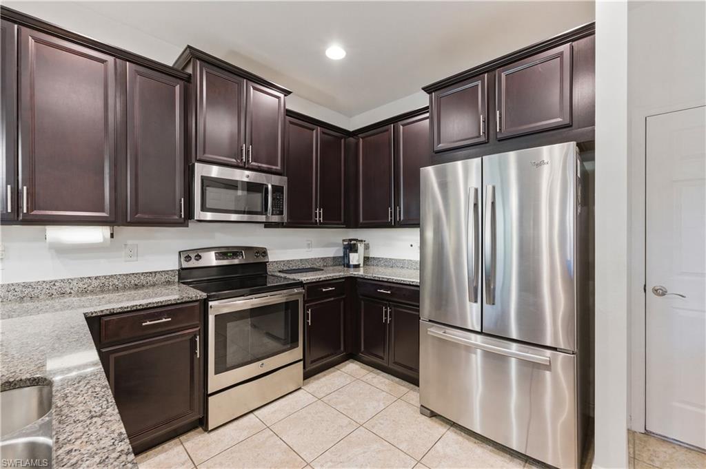 19540 Bowring Park Road, Unit 101 Fort Myers, FL 33967 - Photo 14 of 46 Kitchen with stainless steel appliances (refrigerator, oven, microwave and dishwasher)