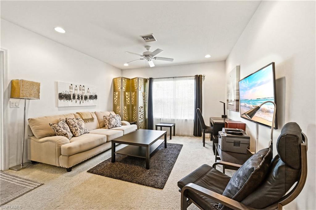 19540 Bowring Park Road, Unit 101 Fort Myers, FL 33967 - Photo 21 of 46 Loft with couch, coffee table, TV and desk with desk chair