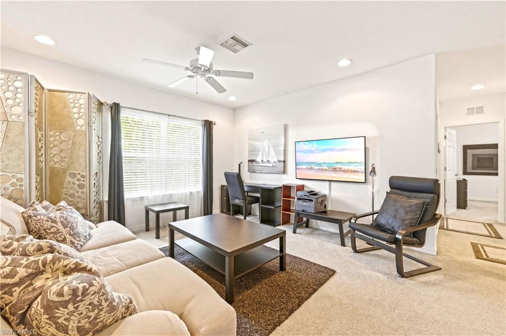 19540 Bowring Park Road, Unit 101 Fort Myers, FL 33967 - Photo 22 of 46 Loft with couch, coffee table, TV and desk with desk chair