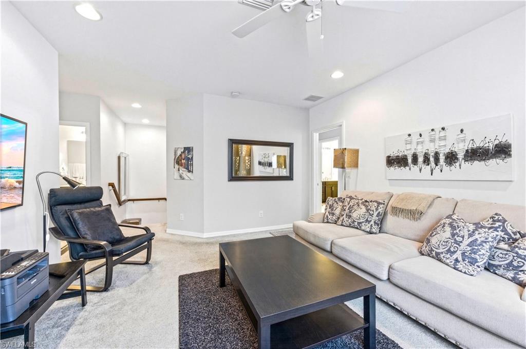 19540 Bowring Park Road, Unit 101 Fort Myers, FL 33967 - Photo 23 of 46 Loft with couch, coffee table, TV and desk with desk chair