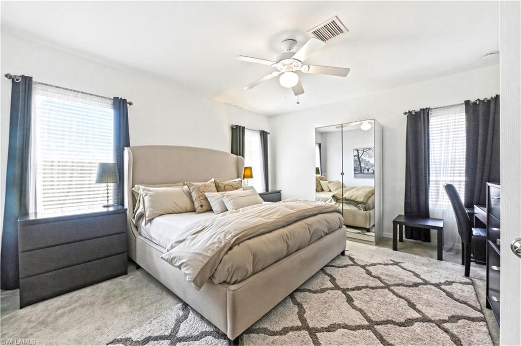 19540 Bowring Park Road, Unit 101 Fort Myers, FL 33967 - Photo 24 of 46 Primary bedroom with a king size bed, dresser, nightstands and TV