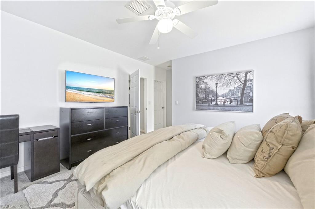 19540 Bowring Park Road, Unit 101 Fort Myers, FL 33967 - Photo 25 of 46 Primary bedroom with a king size bed, dresser, nightstands and TV