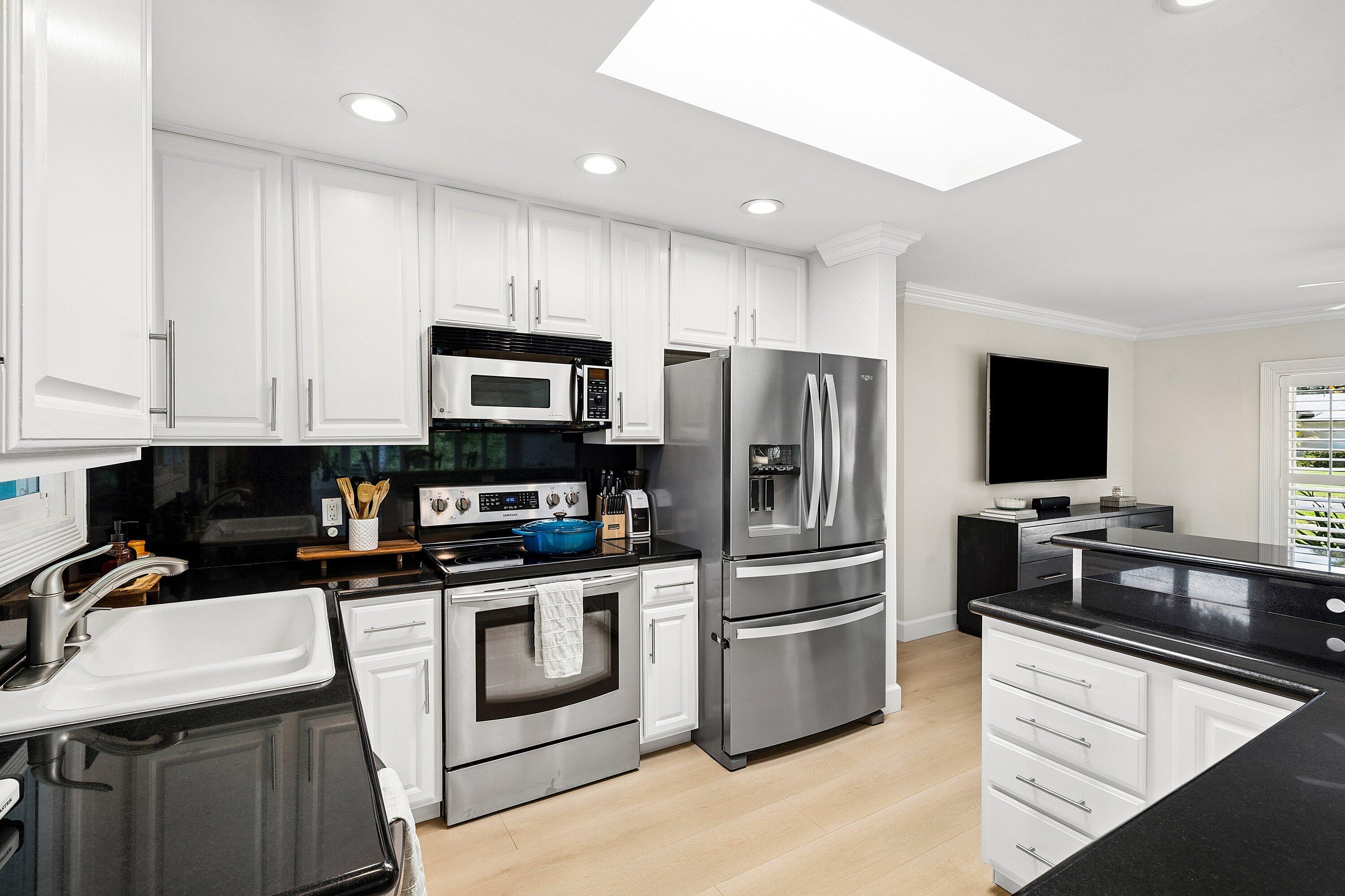 774 Southwest 7th Street Boca Raton, FL 33486 - Photo 11 of 28 a kitchen with a sink stainless steel appliances and cabinets