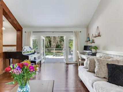a living room with furniture and flowers