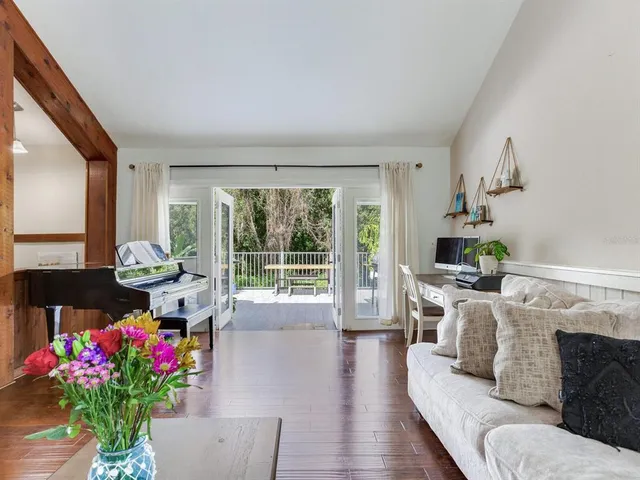 a living room with furniture and flowers