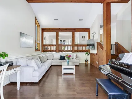 a living room with furniture and a floor to ceiling window