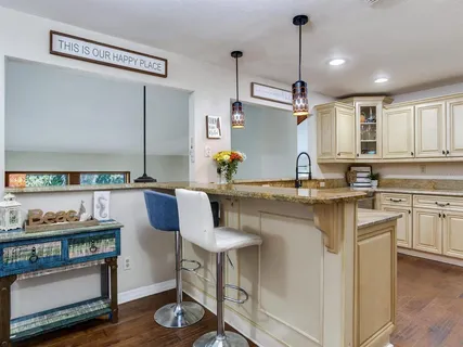 a kitchen with stainless steel appliances granite countertop a stove and a sink