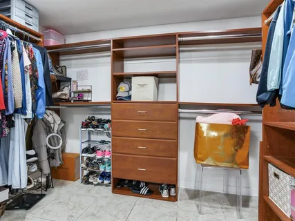 a bathroom with a granite countertop sink mirror vanity and toilet