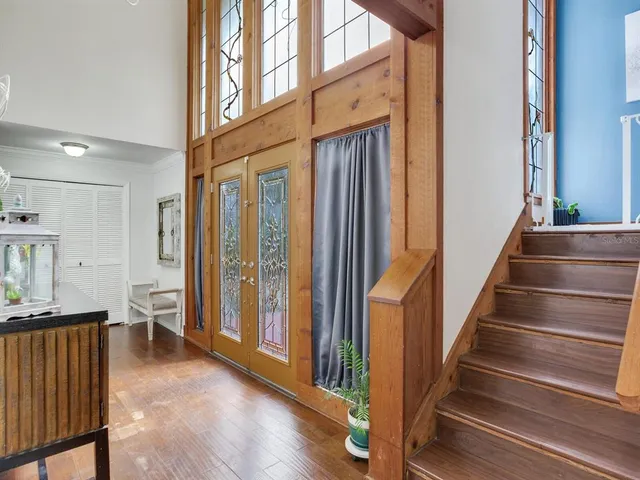 a view of an entryway with wooden floor and windows
