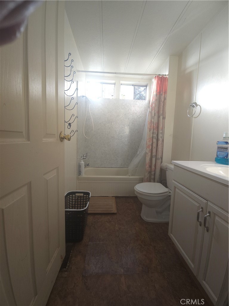 3114 Manzanita Road Nice, CA 95464 - Photo 2 of 10 a bathroom with a granite countertop sink a toilet a mirror and shower